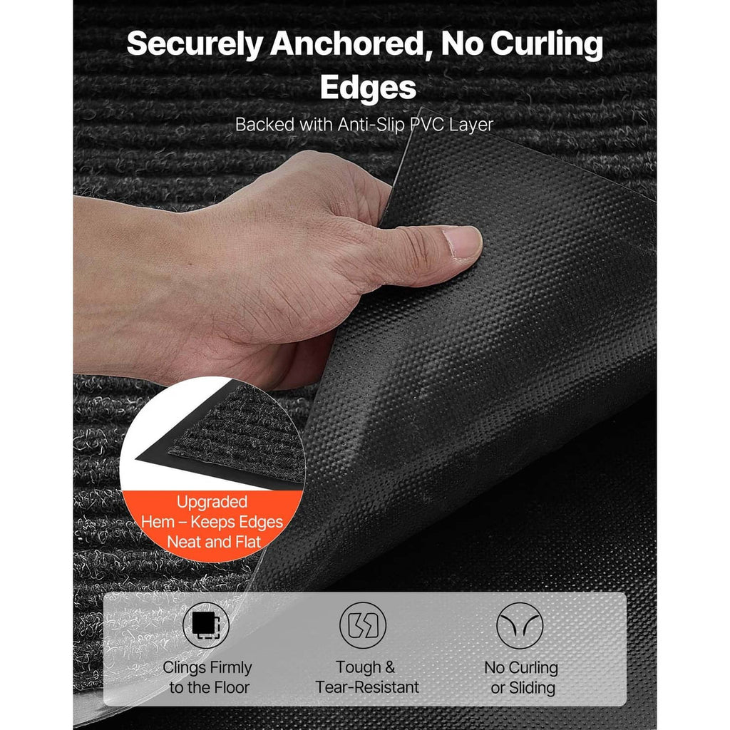Dark doormat with ribbed top and anti-slip backing, corner held flat