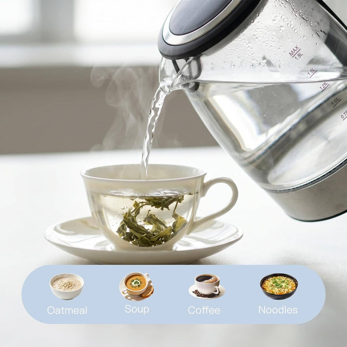 Electric glass kettle pouring hot water into a white cup with tea leaves