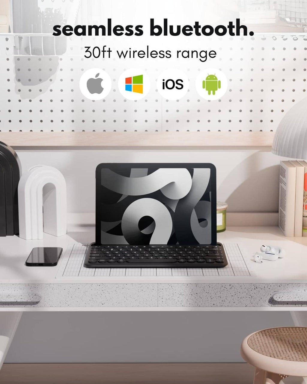 Black Bluetooth keyboard resting on a tabletop with a protective stand