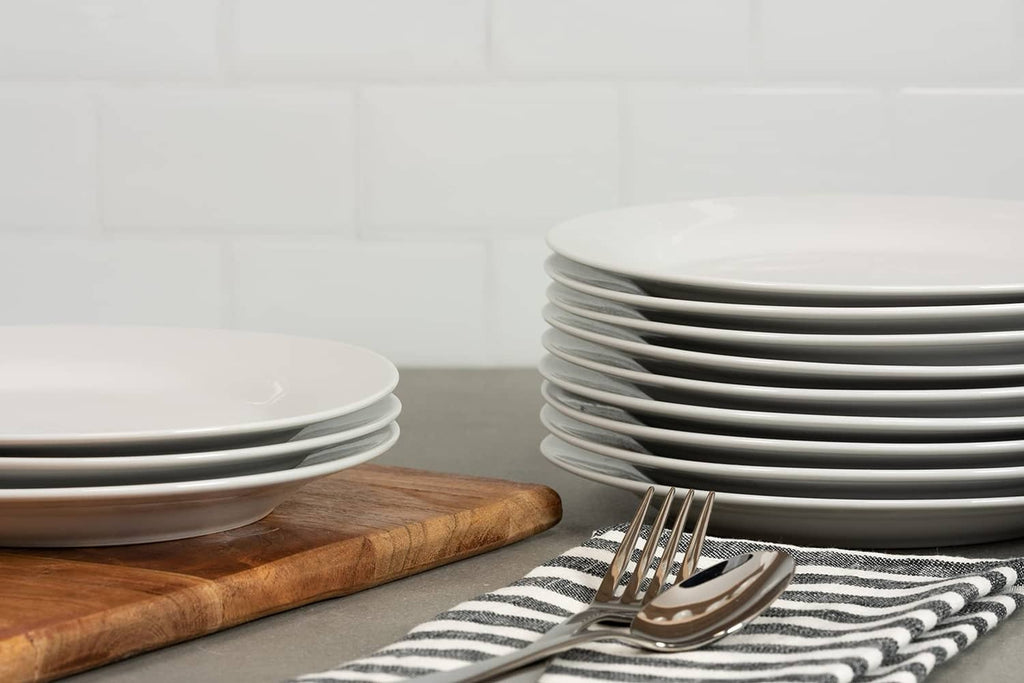 Stack of white round shallow plates for catering salad or dessert