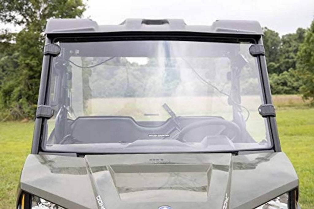 Close-up front windshield panel with black frame and mounting supports