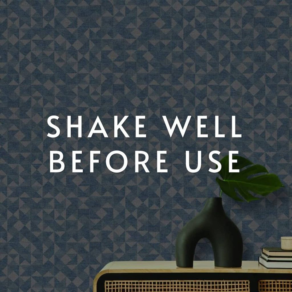 Blue geometric wallpaper surface with a vase on top