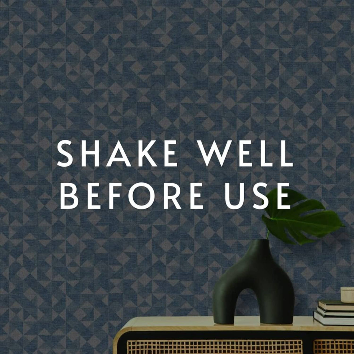 Blue geometric wallpaper surface with a vase on top