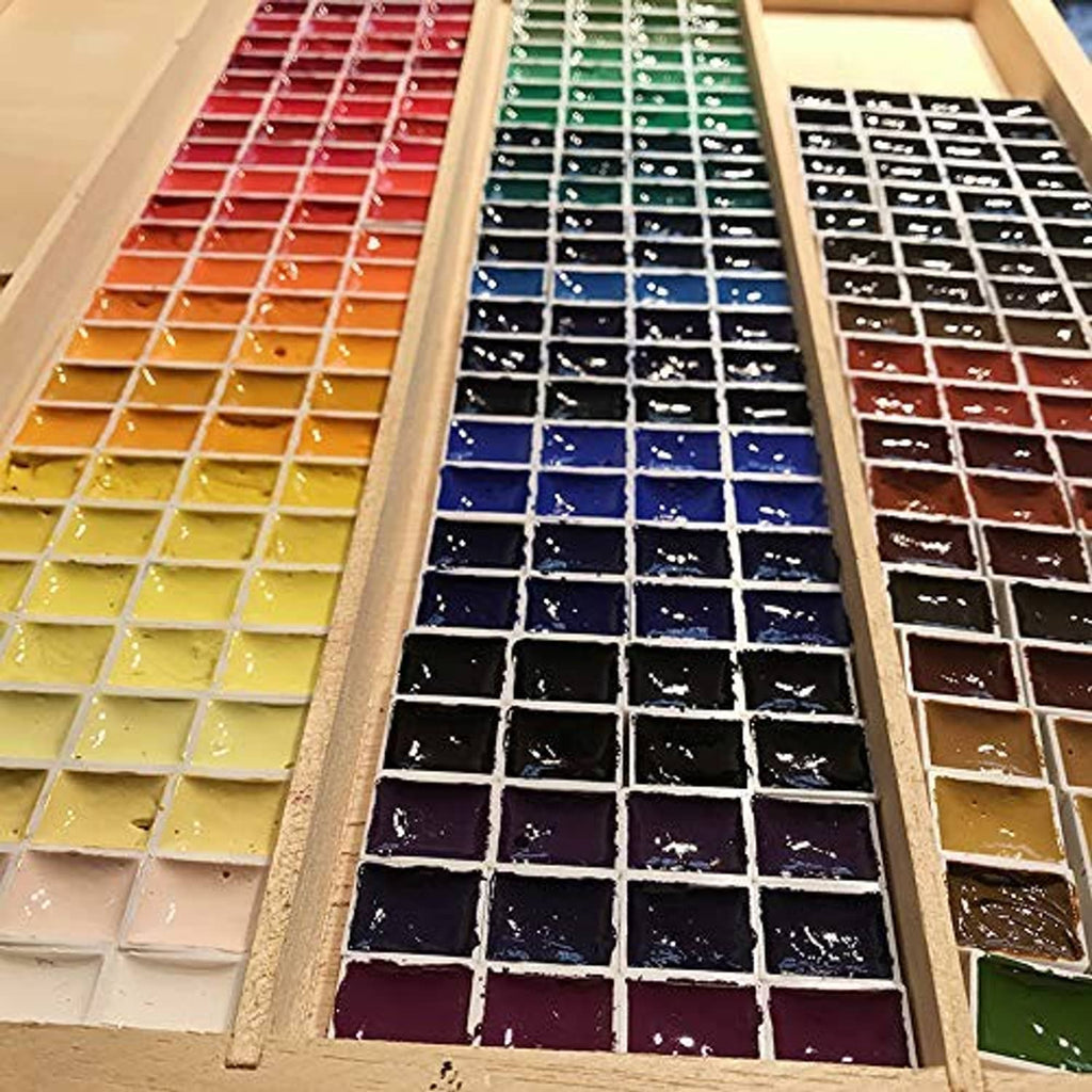 Assorted color watercolor half-pan rows on magnetic palette with square wells