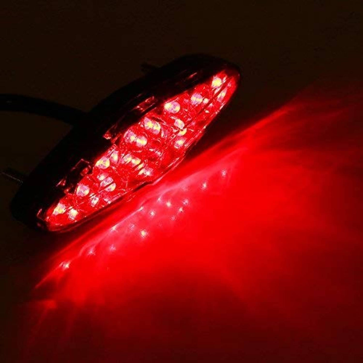 Red illuminated LED motorcycle rear tail light with bright stop light glow