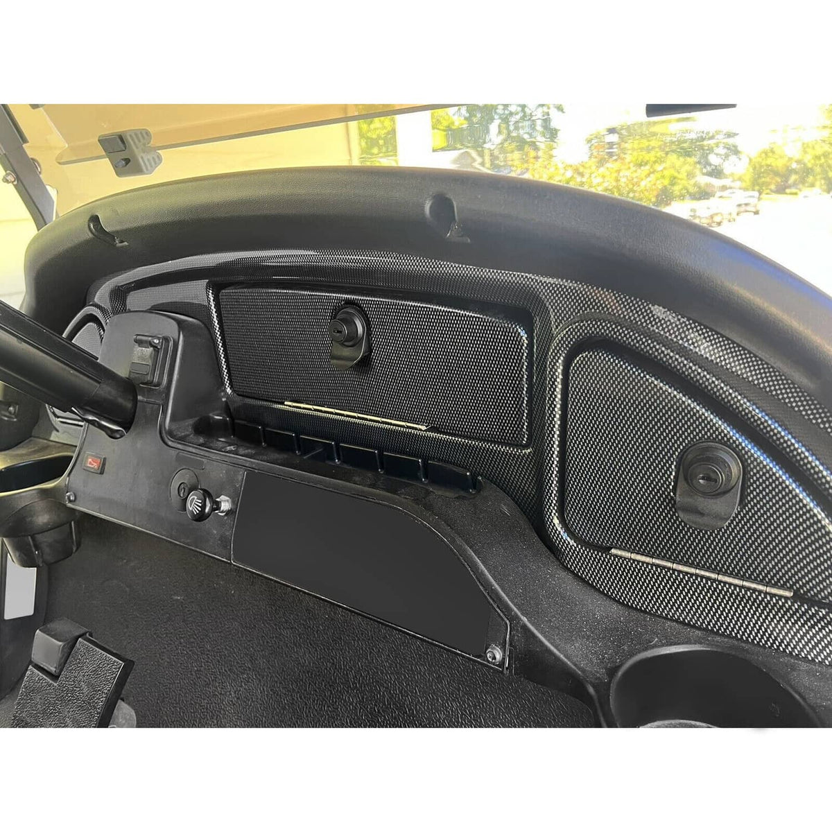 Golf cart dash insert with carbon-fiber-look textured black panels and lock housing