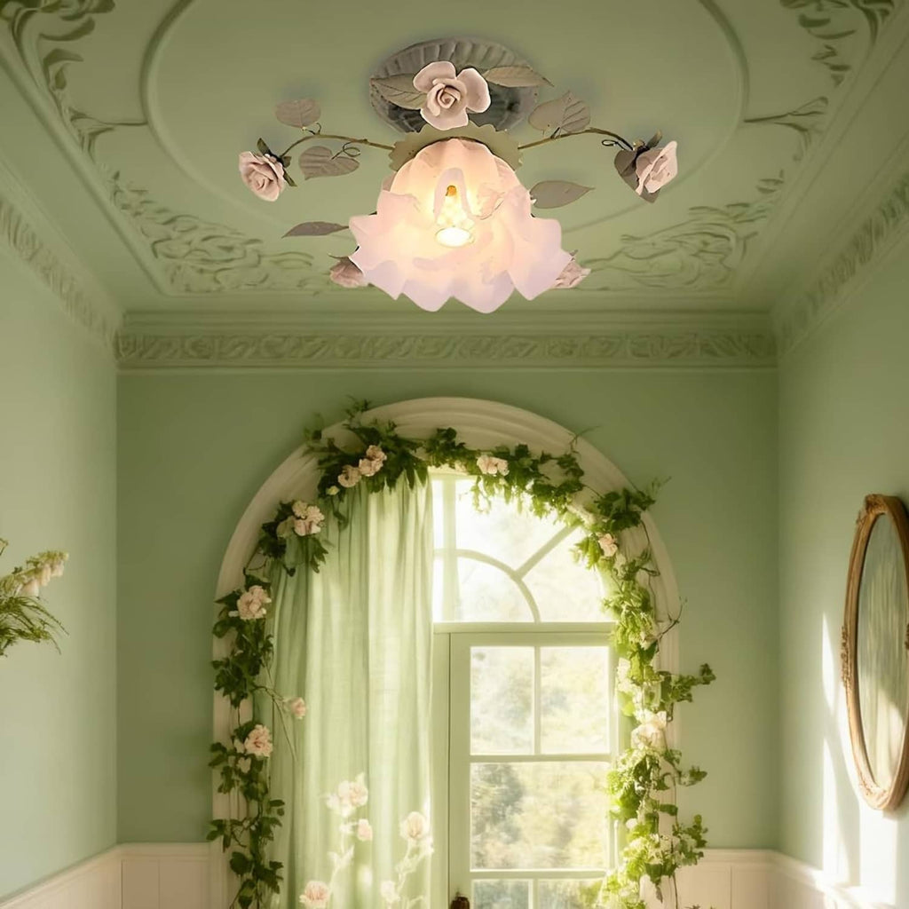 Floral semi-flush ceiling light with green leaf accents and white glass rose shade