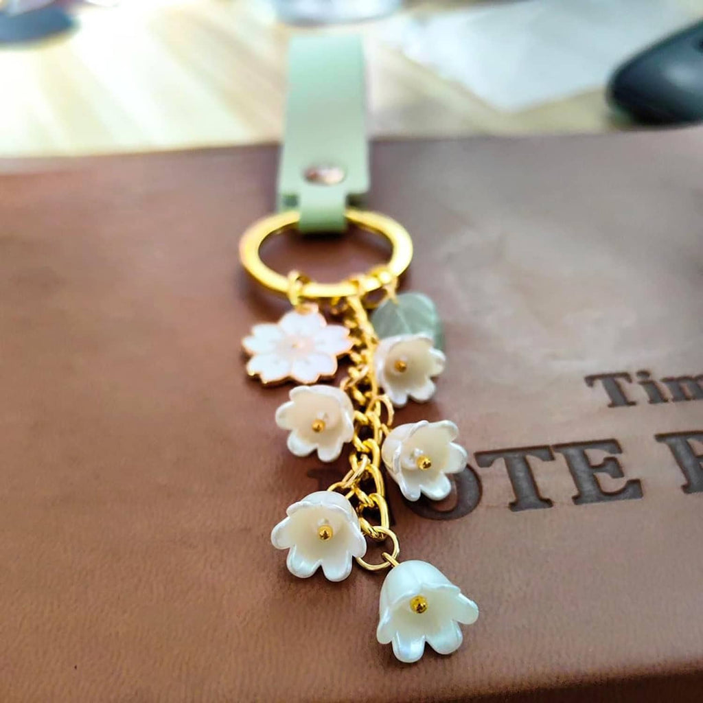 Mint green leather keychain with gold chain and white flower charm tassels