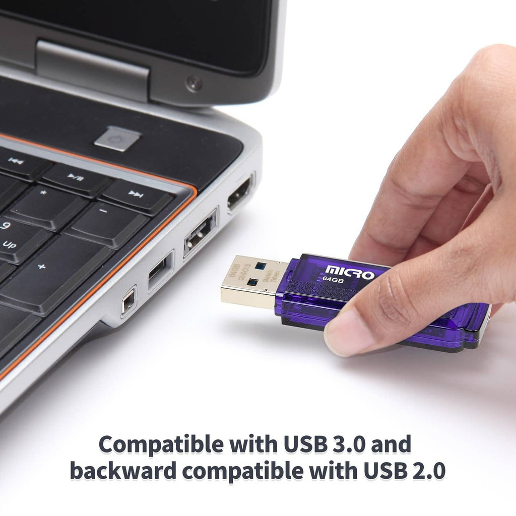 Blue USB 3.0 flash drive being plugged into a laptop USB port