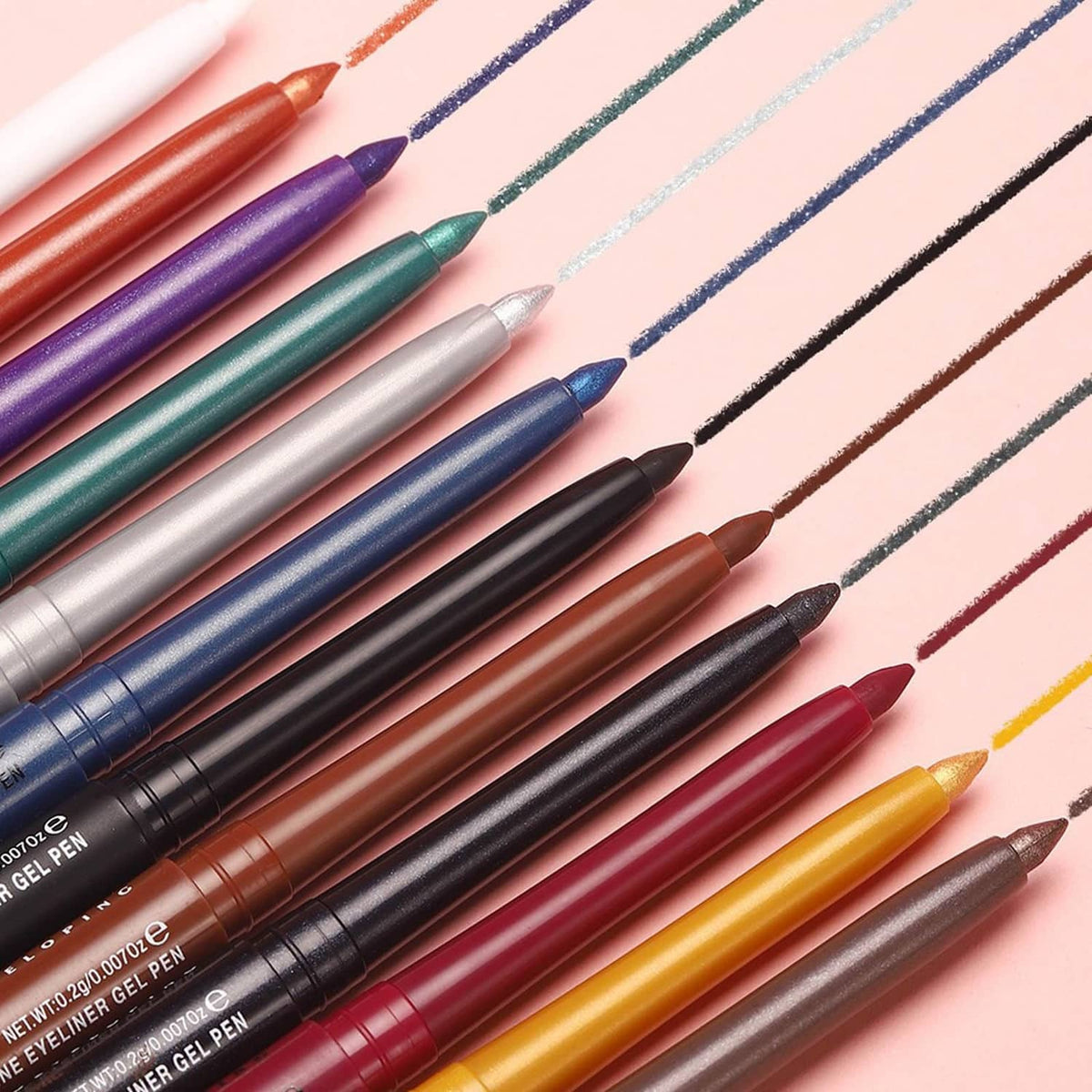 Assorted gel eyeliner pencils in multiple colors with tapered tips and drawn swatches
