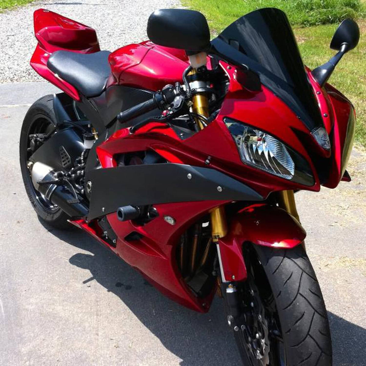 Front headlight assembly for sport motorcycle with clear lens and black mounting frame.