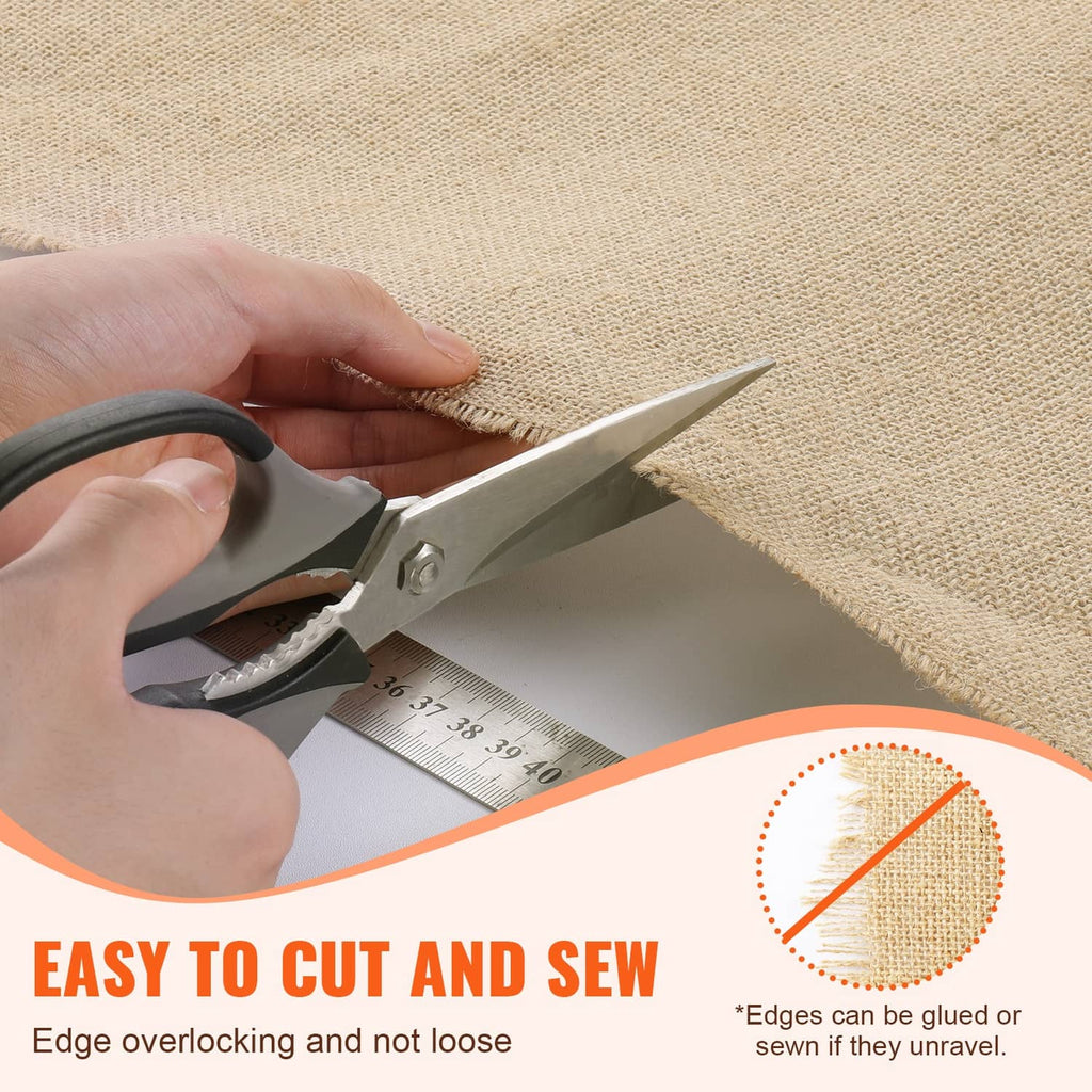 Hand cutting tan burlap fabric roll with scissors on woven jute