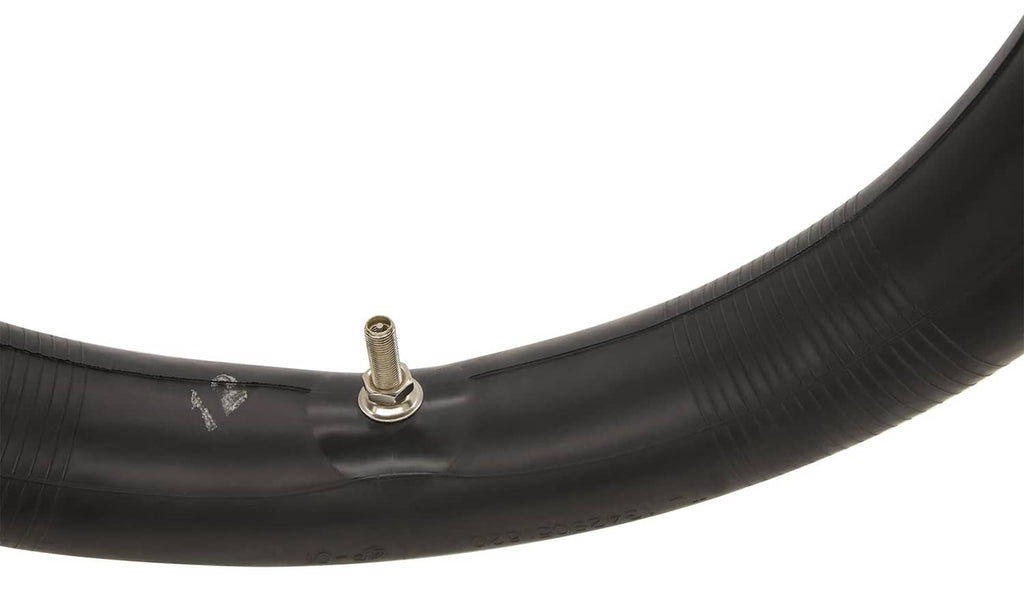 Black inner tube close-up with metal valve stem and textured rubber surface