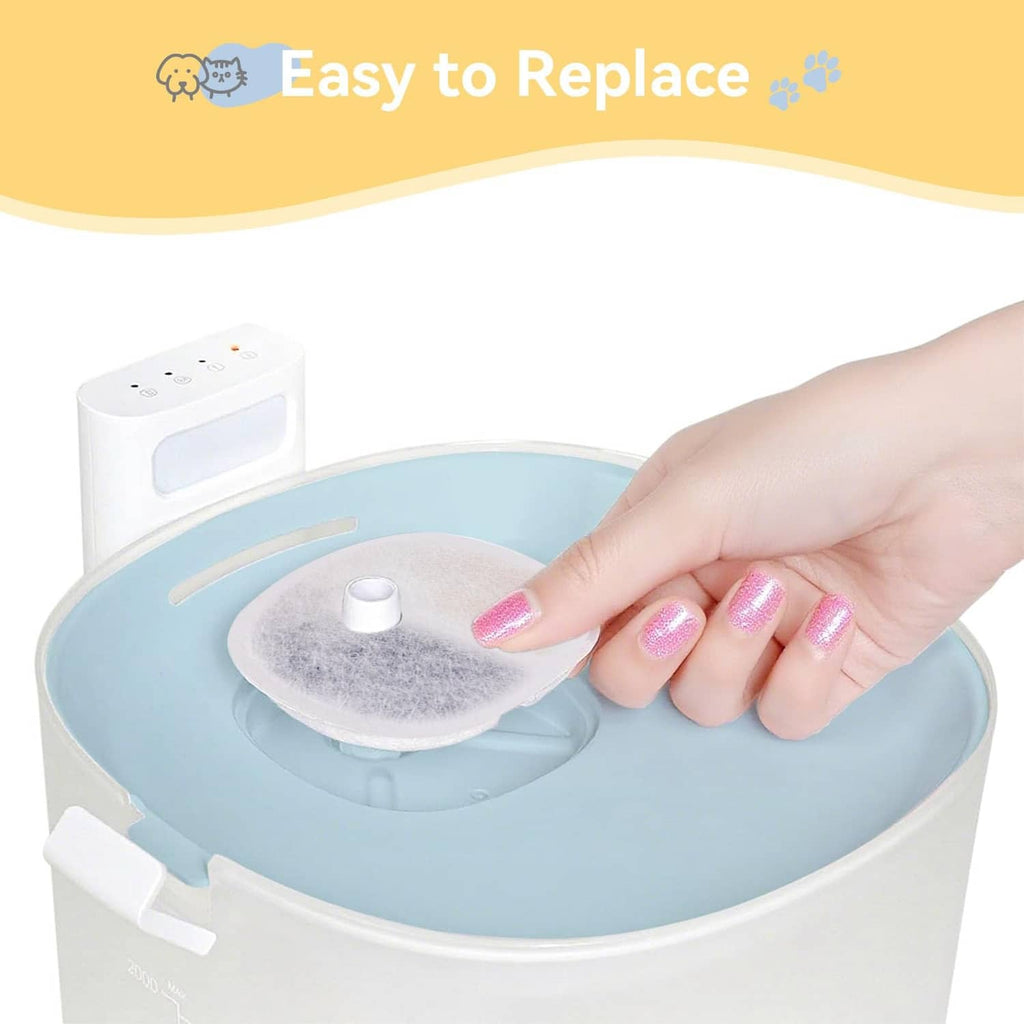 Hand inserting a round replacement filter pad into water fountain reservoir