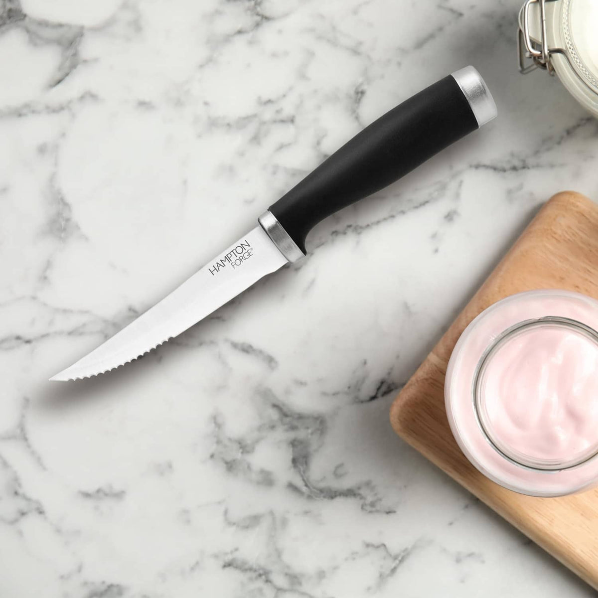 Hampton Forge steak knife close-up, black handle with silver serrated blade