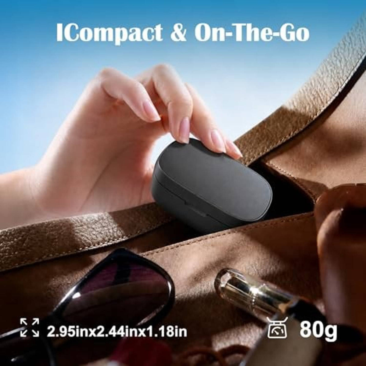 Black portable charging case on leather bag strap, held in hand