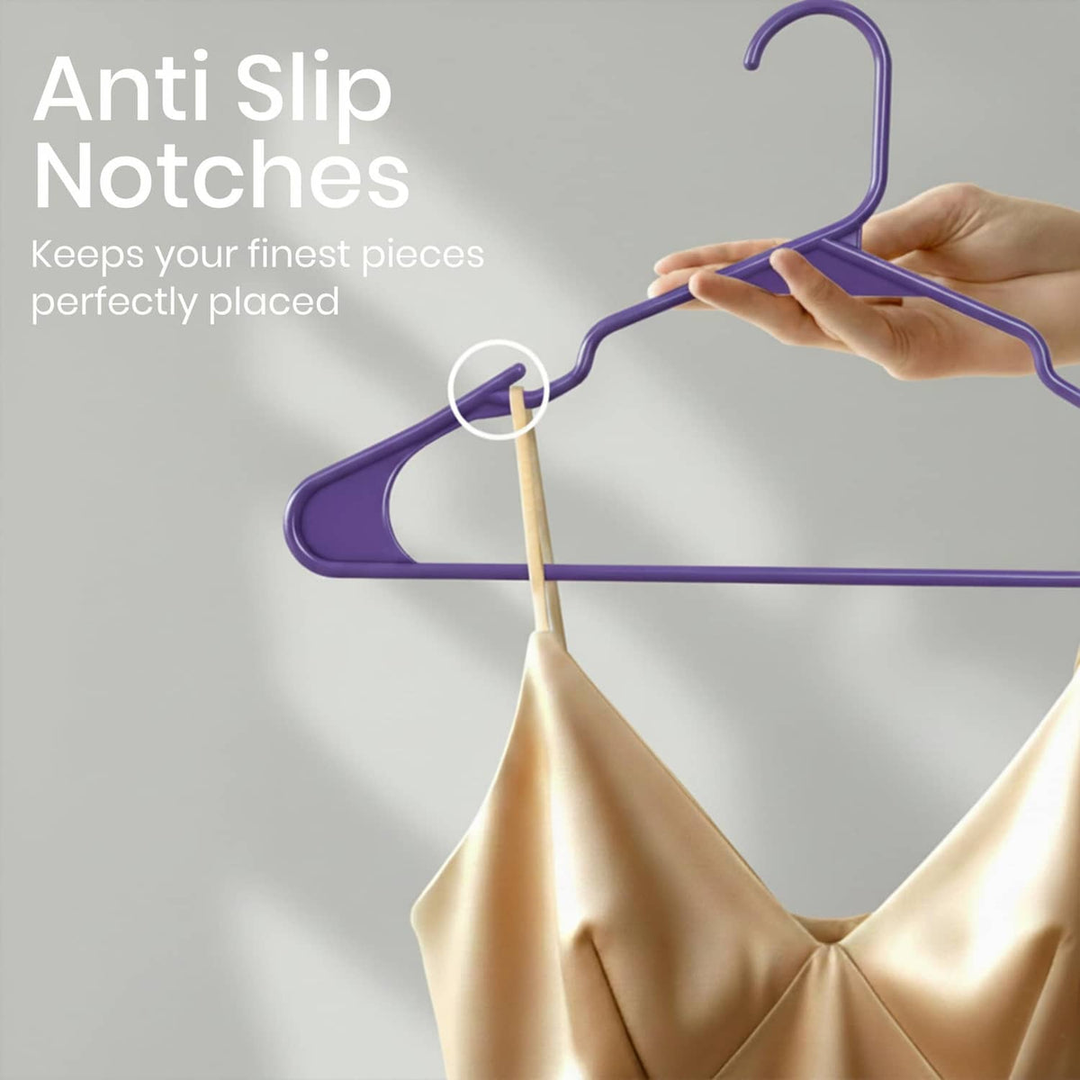 Purple plastic clothes hanger with anti-slip notches on the shoulders