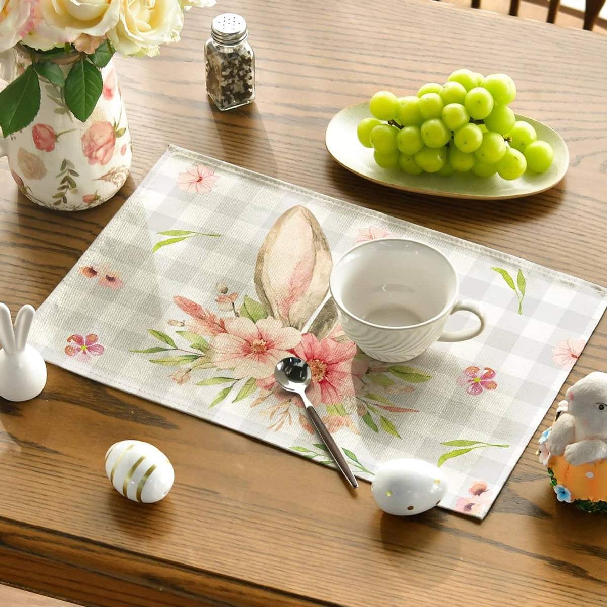 Beige plaid bunny-ear floral rectangular placemat with servingware on top.