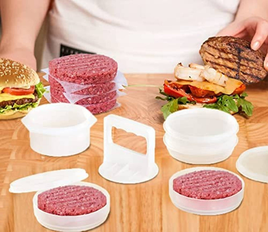 White freezer containers and patty molds with raw burger patties on wooden table