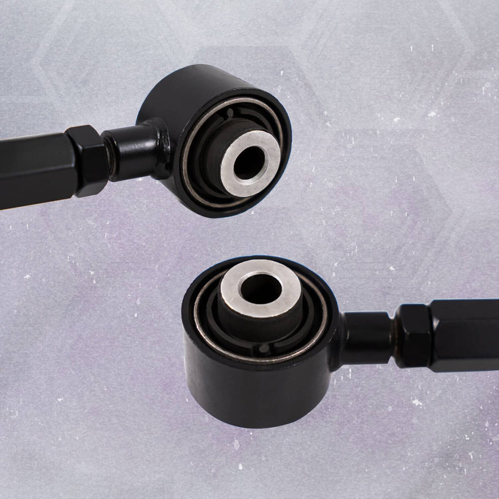 Close-up of black control arm bushings with metal center rings and rod end joints