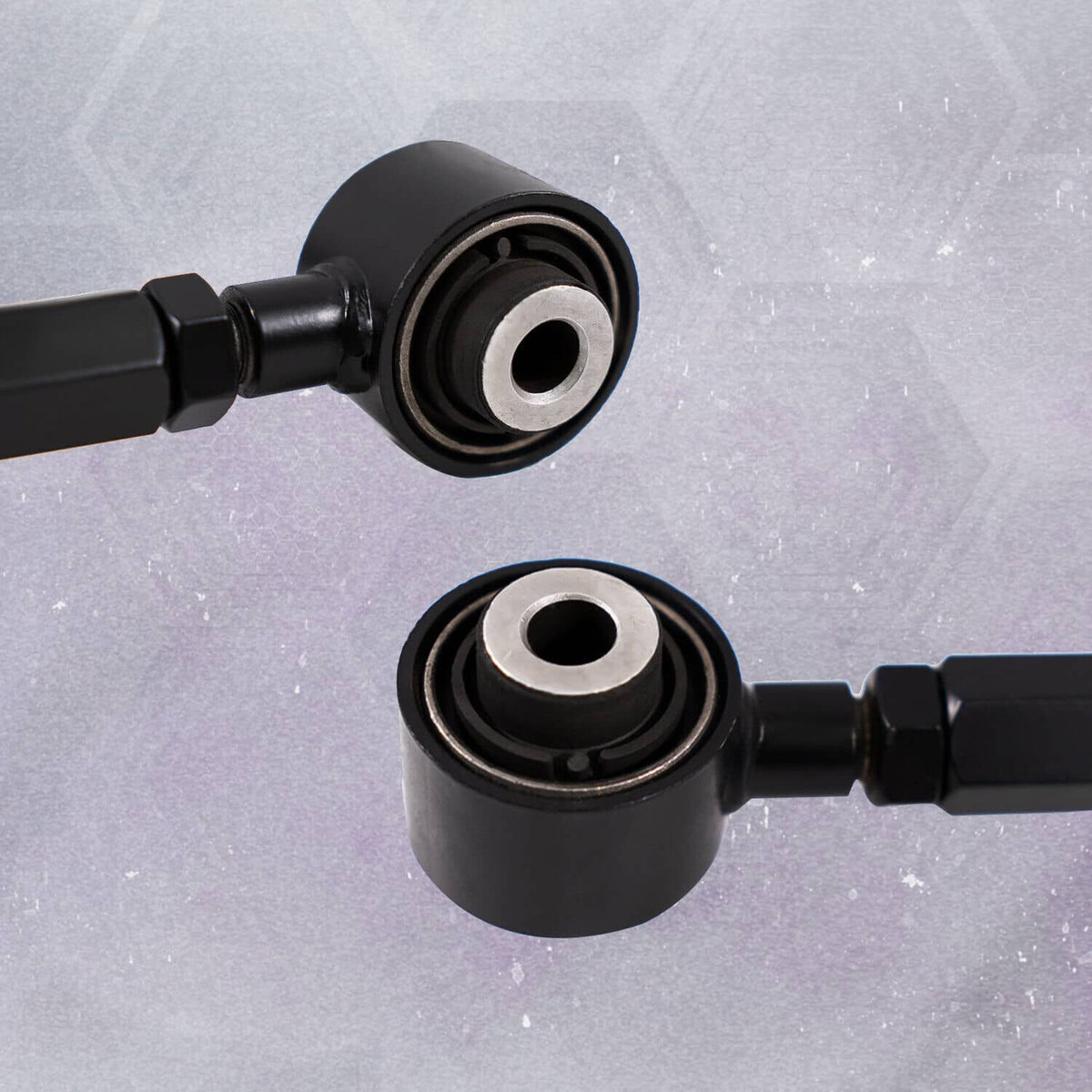 Close-up of black control arm bushings with metal center rings and rod end joints