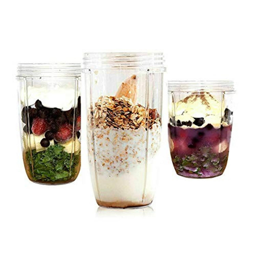 Set of three blender cups filled with berries, greens, and granola