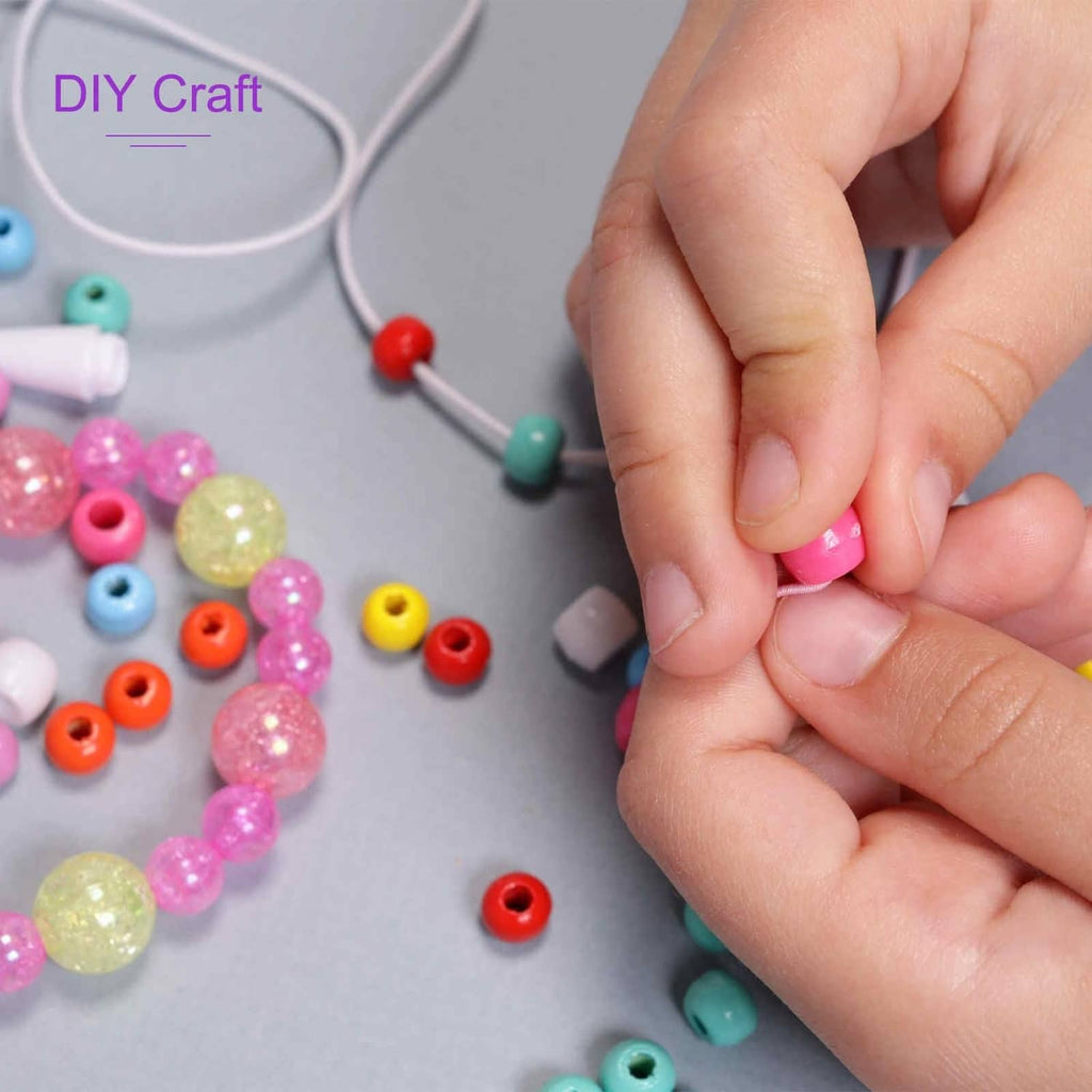 Brown elastic cord held in hands while threading beads for bracelet making
