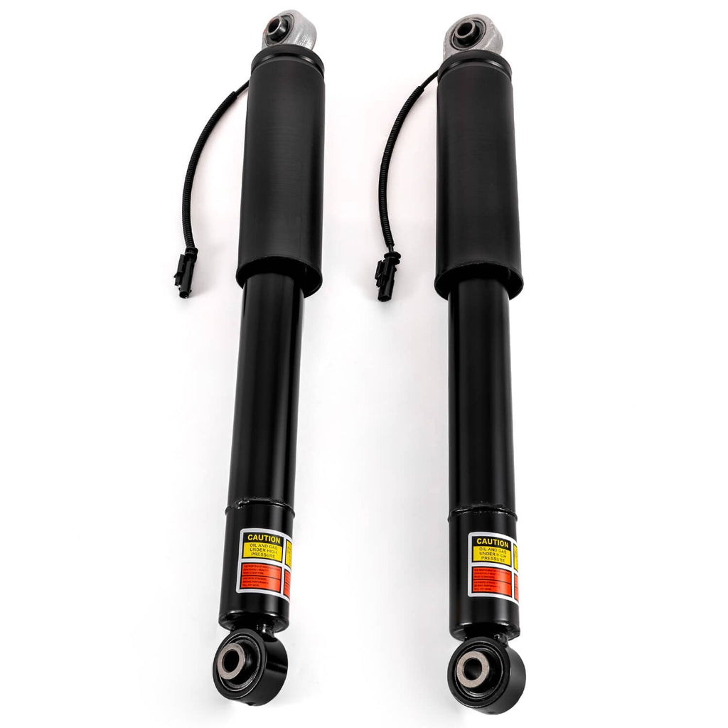 Black rear shock struts with caution labels, top stems, and bottom rubber bushings