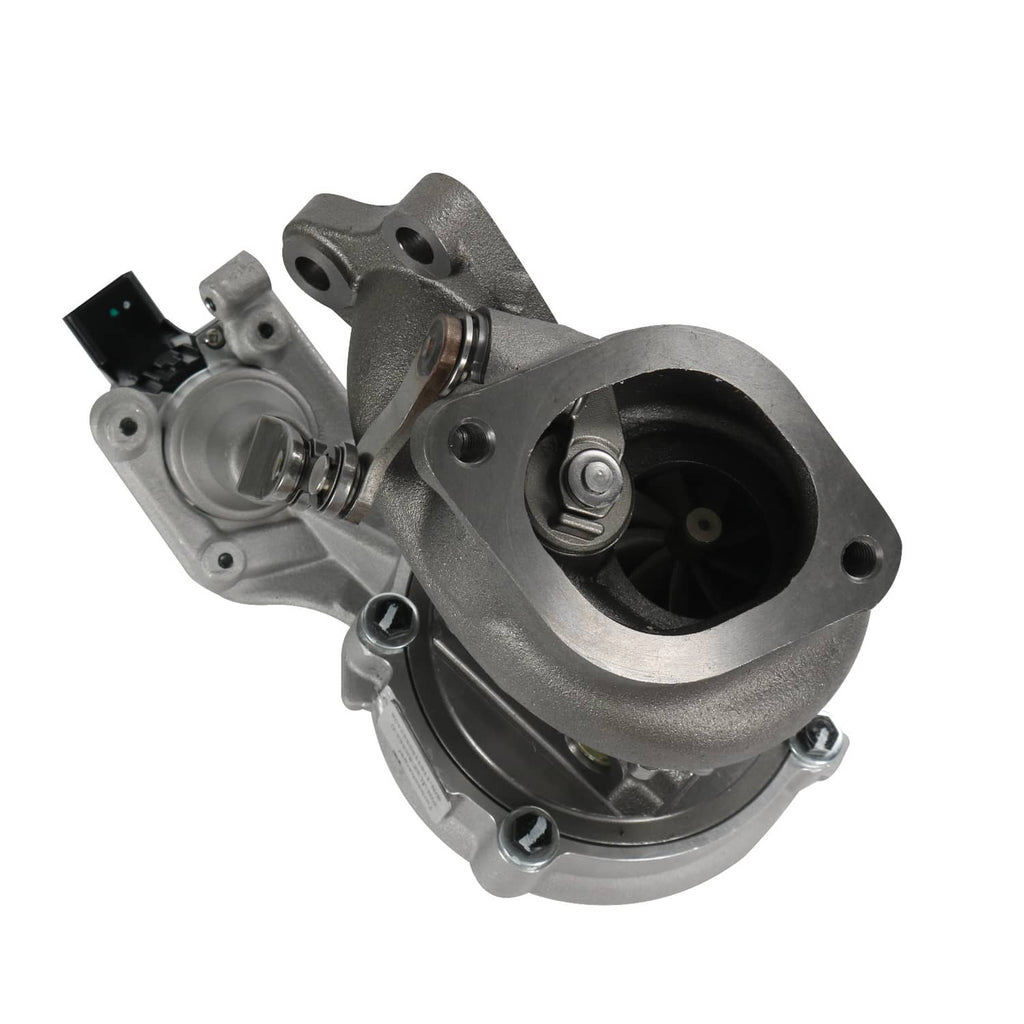 Turbocharger with black outlet opening and silver turbine housing, angled close-up