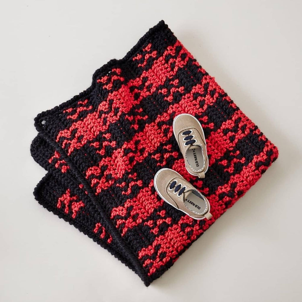 Knitted chevron swatch in black and red with two sewn buttons
