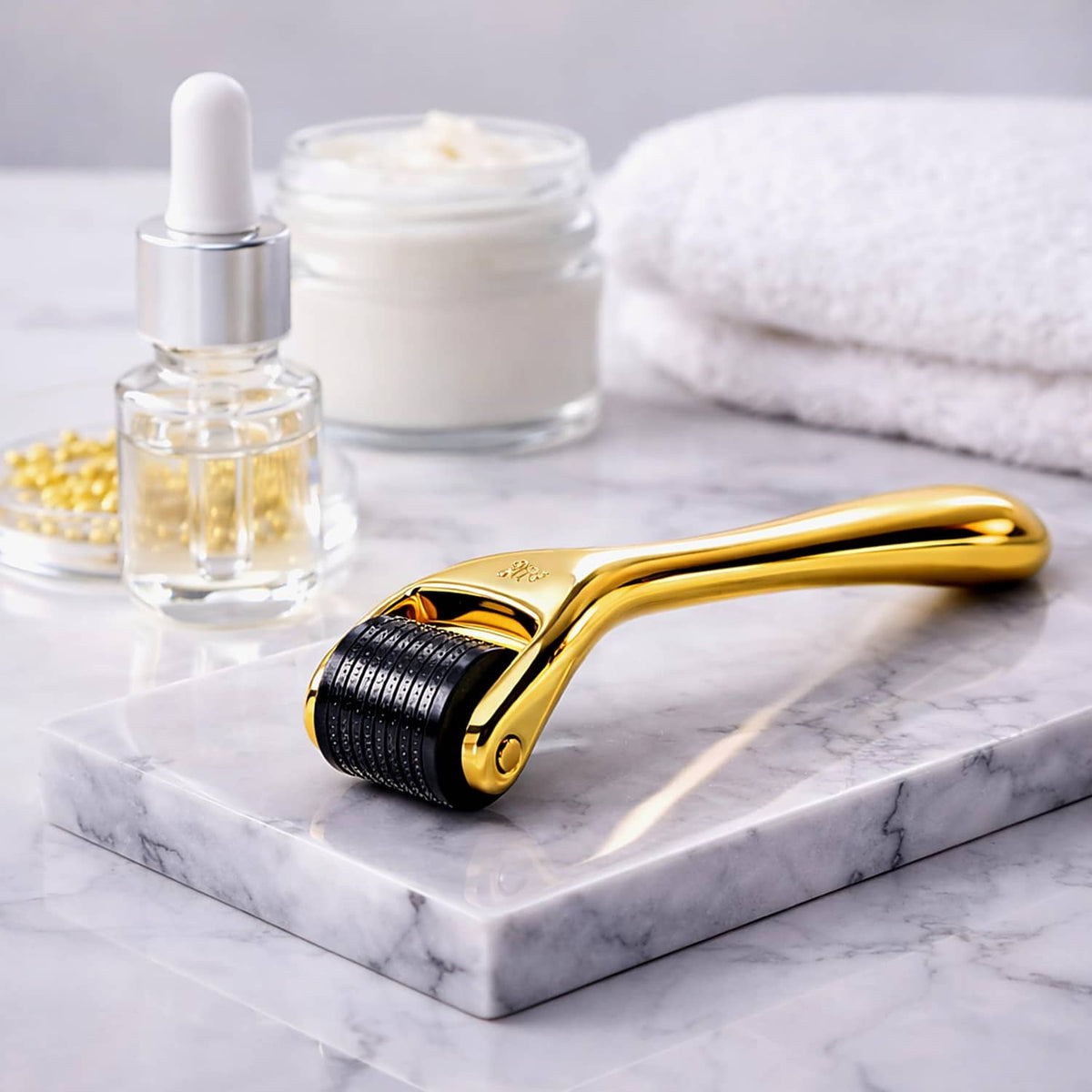 Gold microneedle derma roller on marble with skincare bottles nearby
