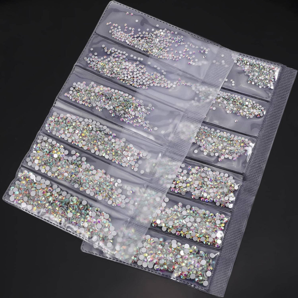 Clear rhinestone storage organizer with compartments, filled with round AB flat-back gems.