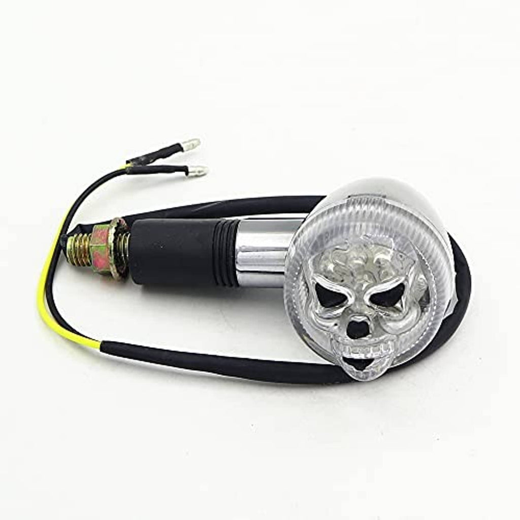 Skull-shaped motorcycle turn signal light with clear lens, chrome body, black cable, plugs