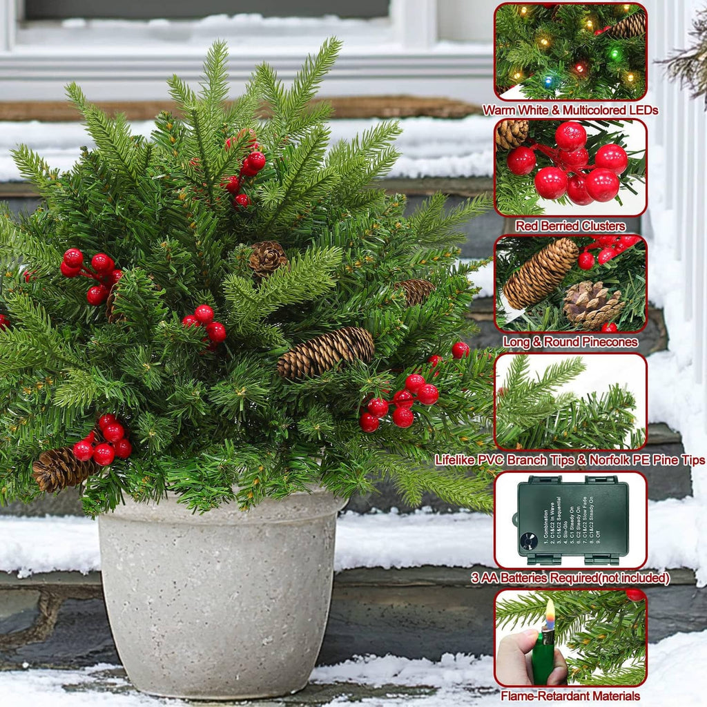 Pre-lit artificial Christmas tree with red berries, pinecones, and multicolor LED lights in planter