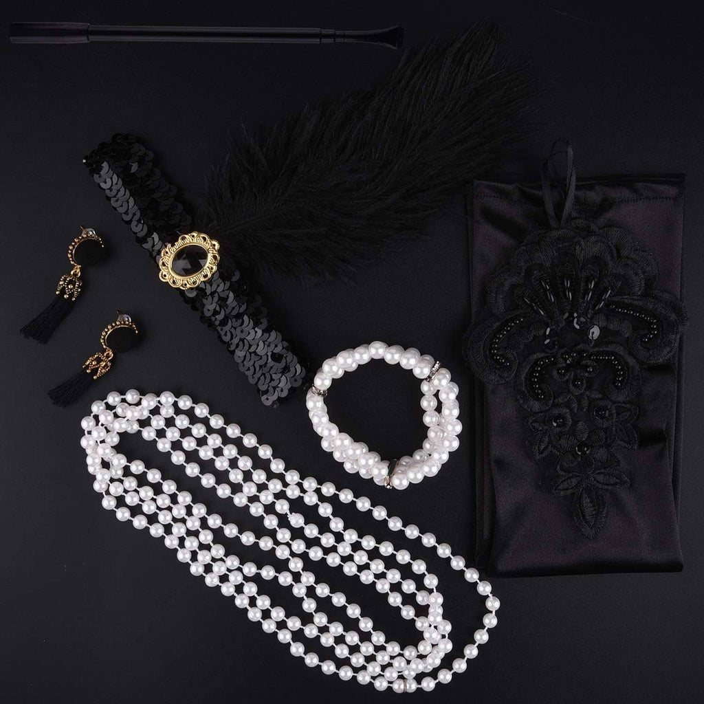 Flapper accessories flat lay: feather headband, pearl necklace strands, tassel earrings, gloves