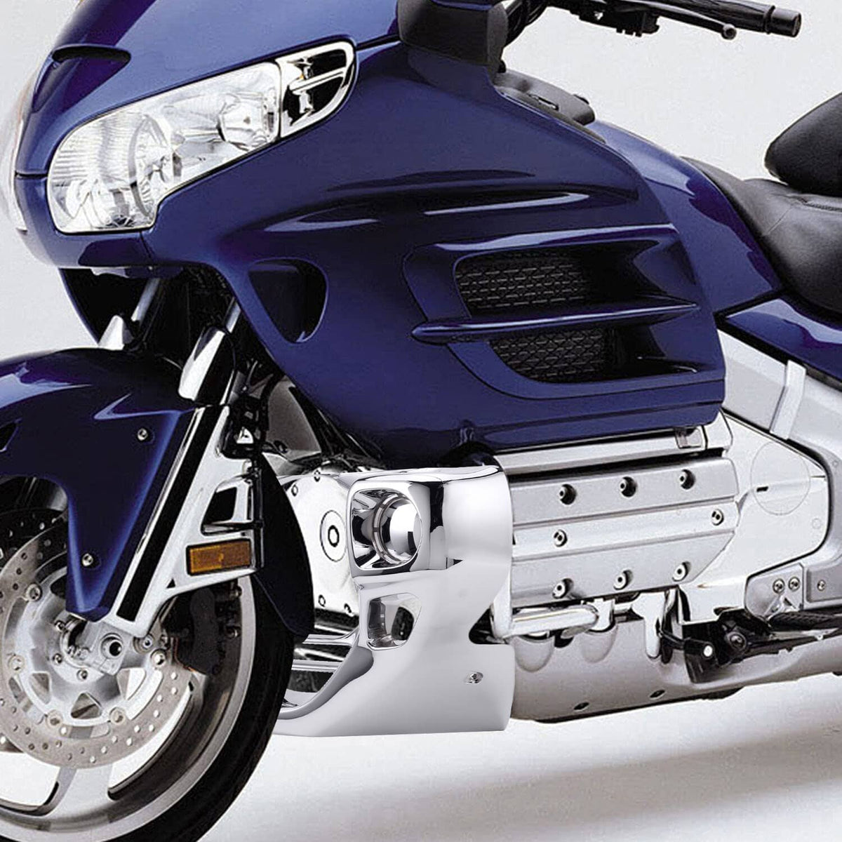 Chrome engine front cowl cover on blue touring motorcycle, front lower area