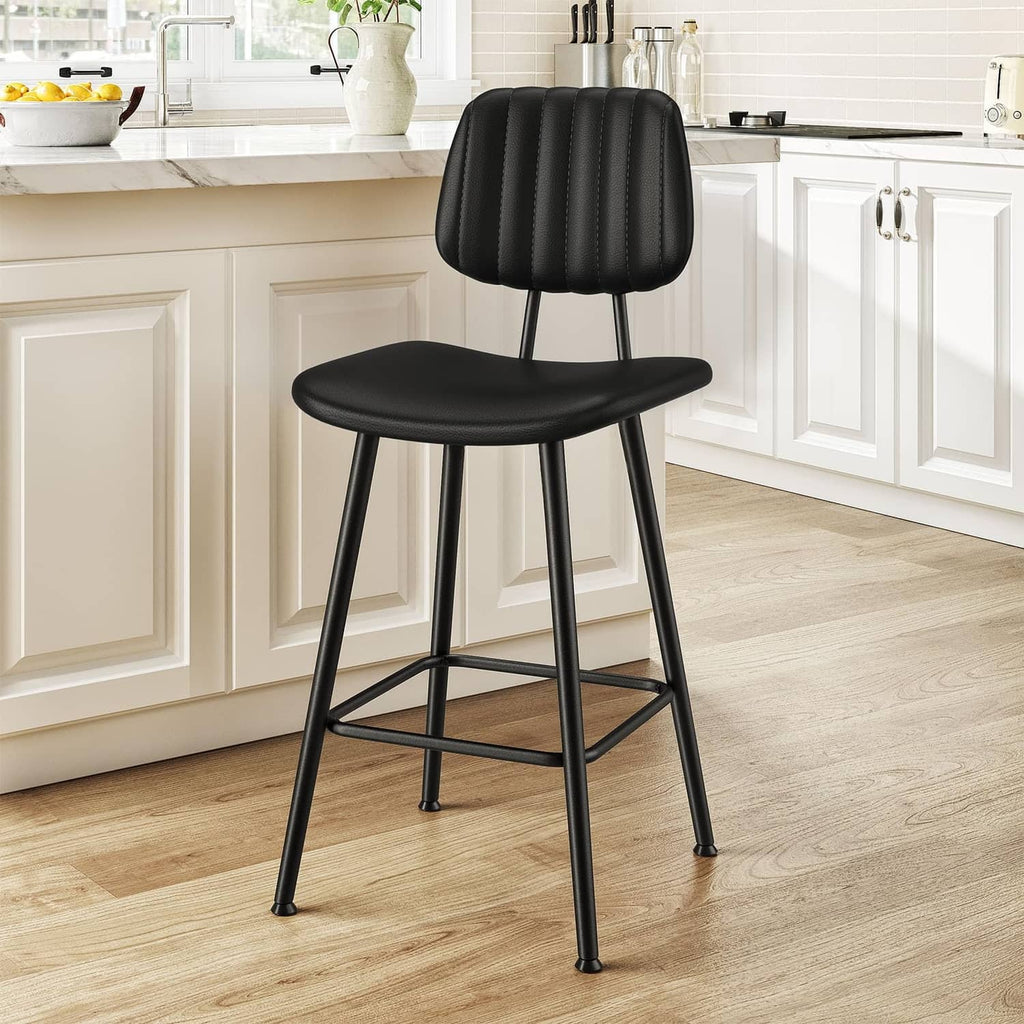 Black counter-height bar stool with padded back, cushioned seat, and metal footrest.