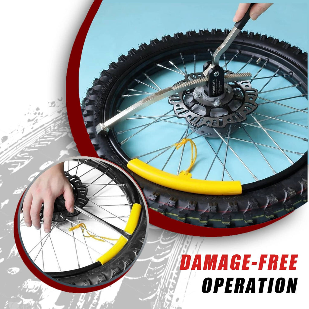 Tire changing tool with yellow lever on a dirt bike wheel rim and tire