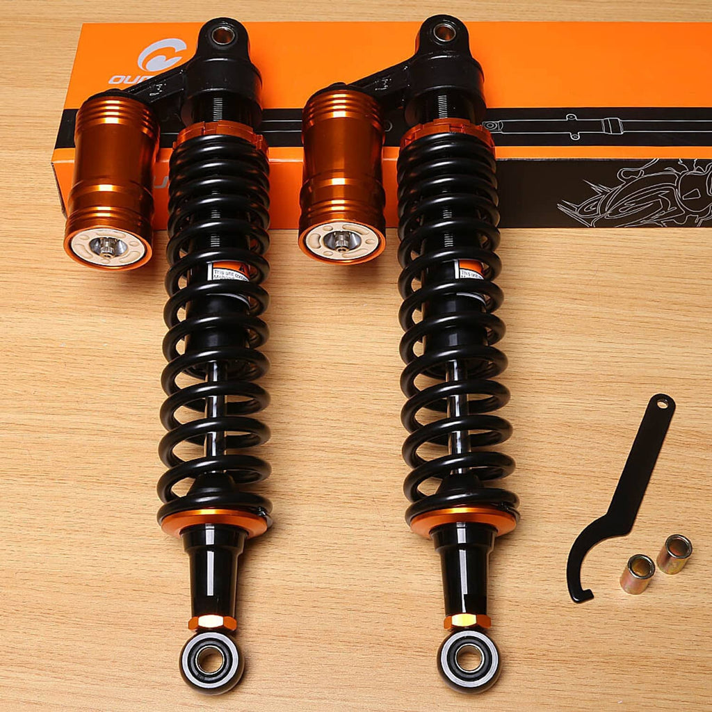 Two air shock absorbers with orange-gold reservoirs, black springs, and install wrench