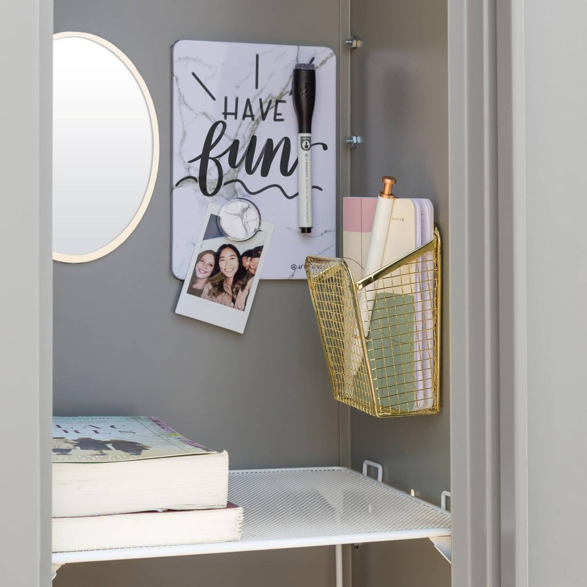 Locker organizer kit mounted on locker wall with marble board, round mirror, and mesh basket