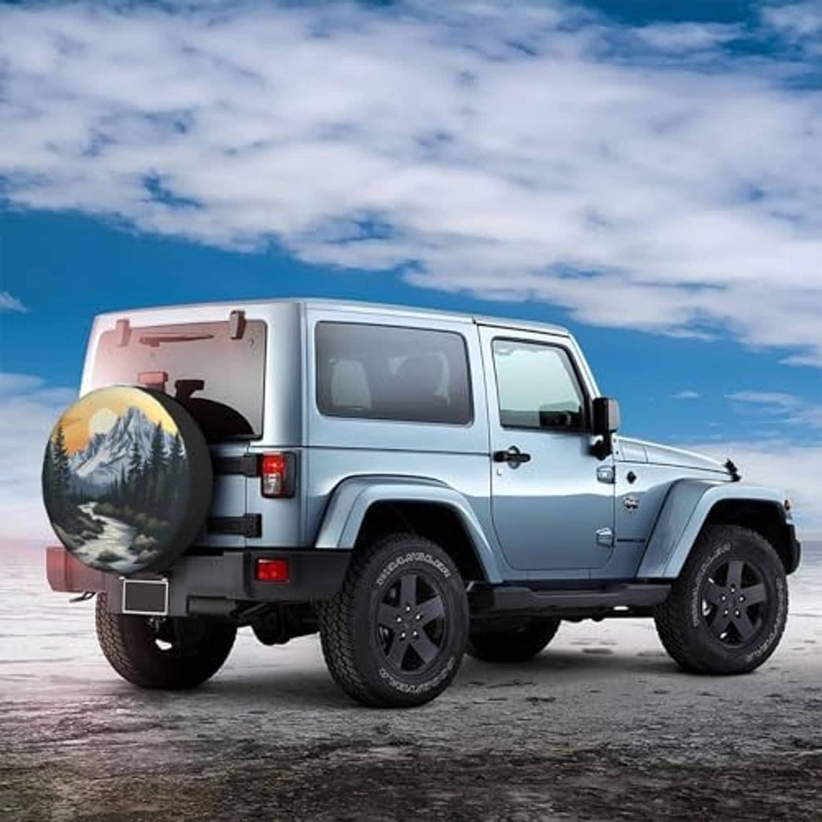 Spare tire cover with mountain sunset graphic on back of off-road vehicle