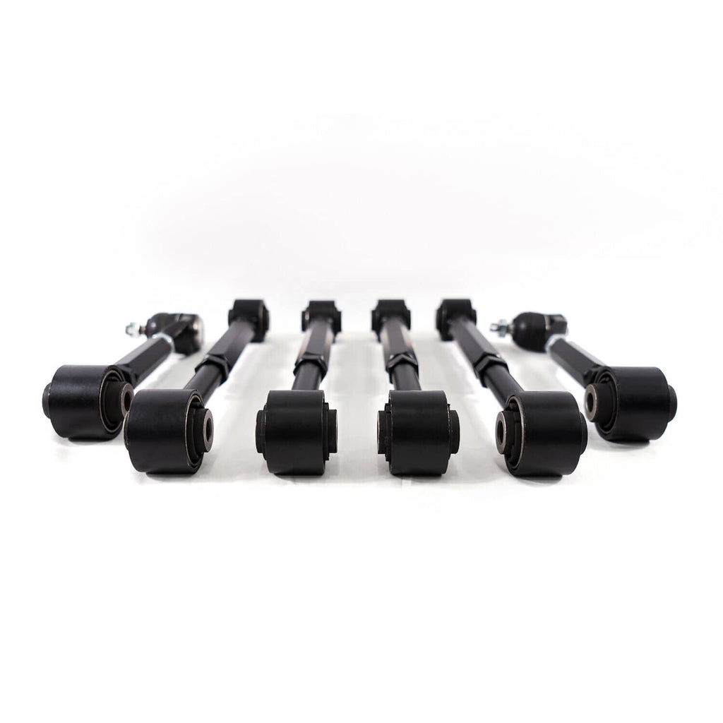 Complete set of six black rear suspension control arms laid out with end bearings