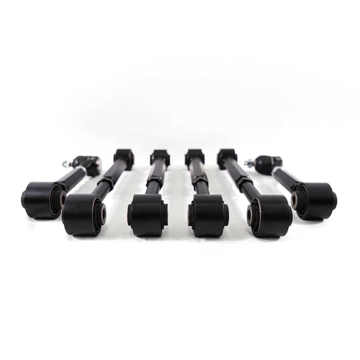 Complete set of six black rear suspension control arms laid out with end bearings