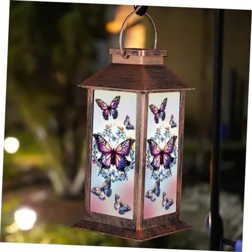 Bronze solar lantern with butterfly-pattern glass panels and hanging loop handle