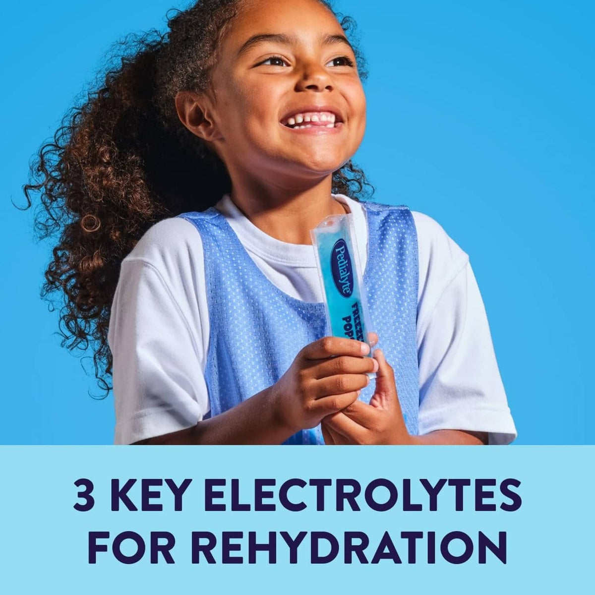 Child holding Pedialyte Freeze Pops electrolyte stick in colorful wrapper