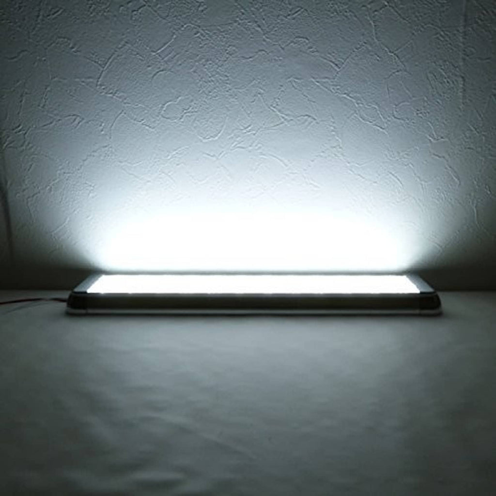 LED dome light fixture illuminating a wall surface with cool-white light