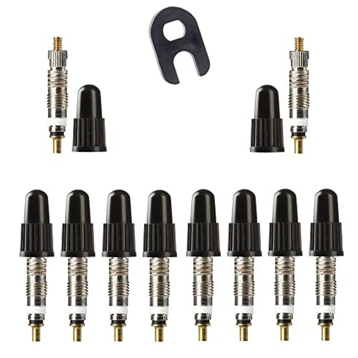 Tubeless Presta valve cores and black caps with removal tool, shown close up.