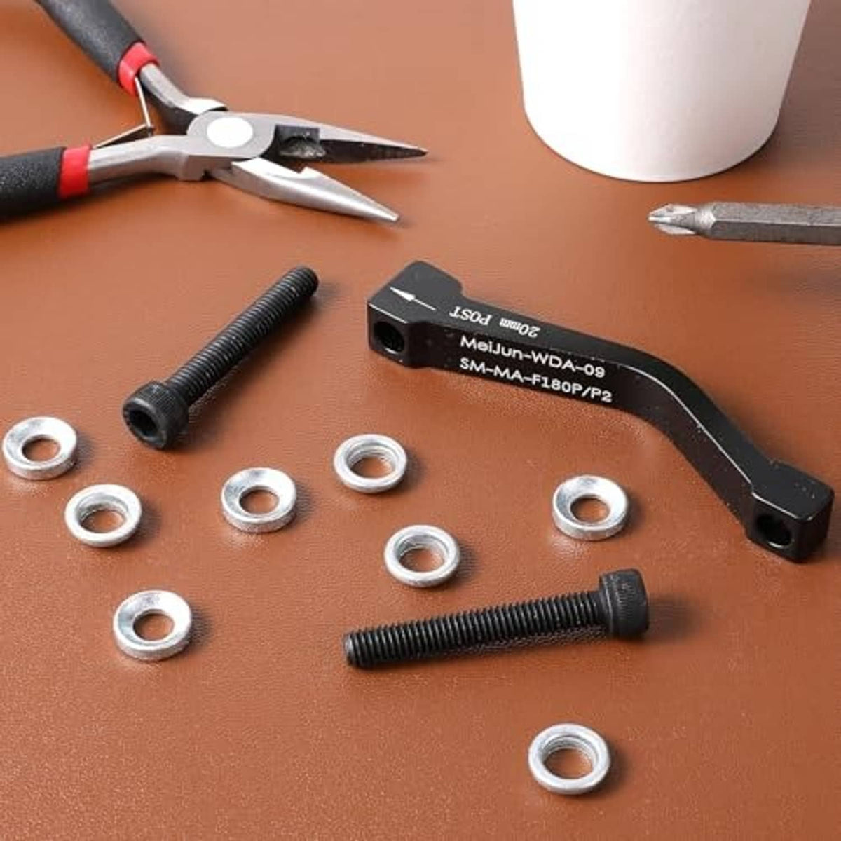 Black 20mm post mount disc brake caliper adapter with bolts and round washers