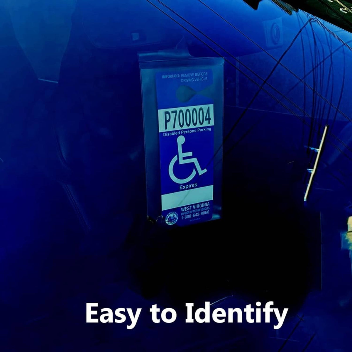 Clear PVC handicap placard holder with metal hook and blue disabled parking label at night
