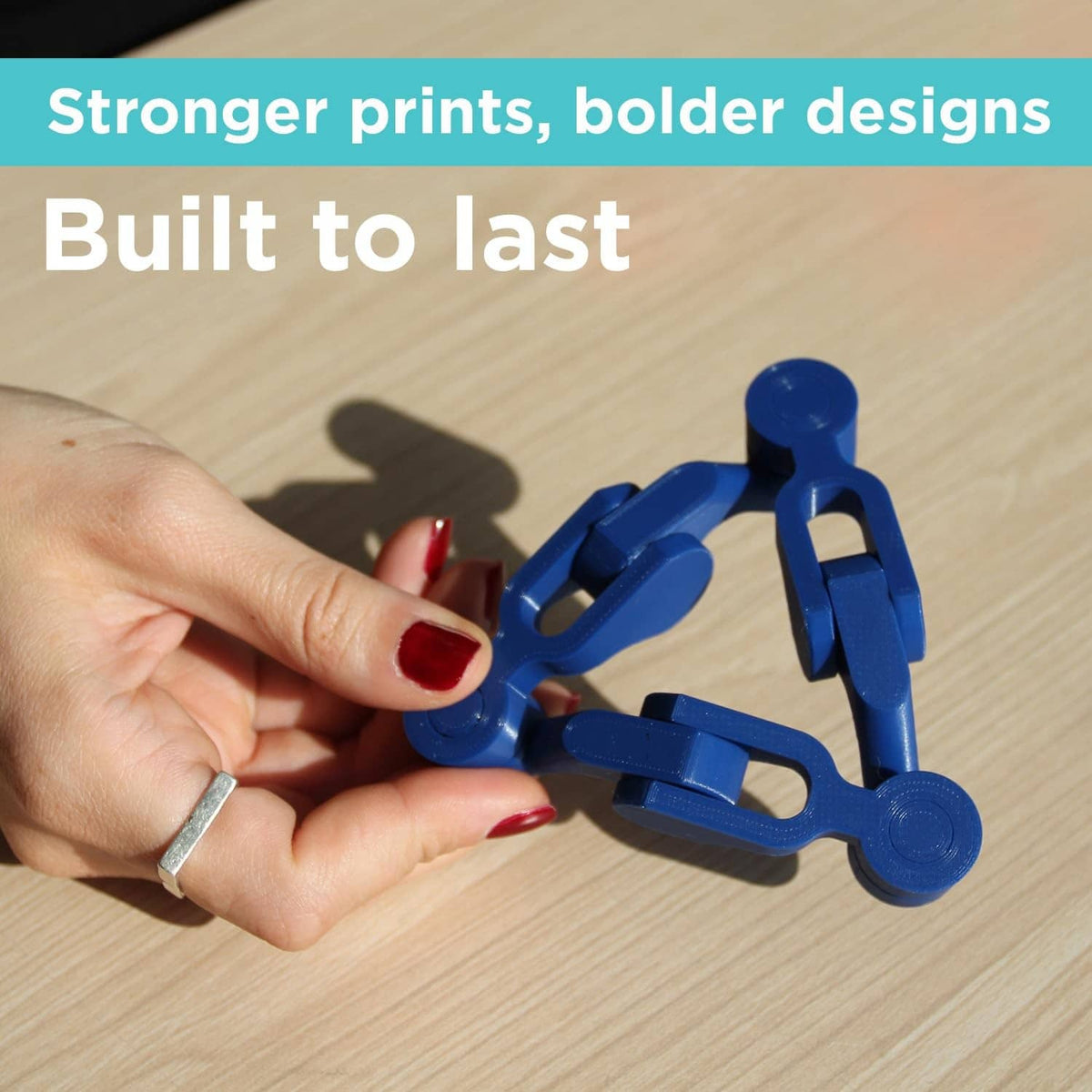 Blue PLA filament strand and blue clips held in a hand
